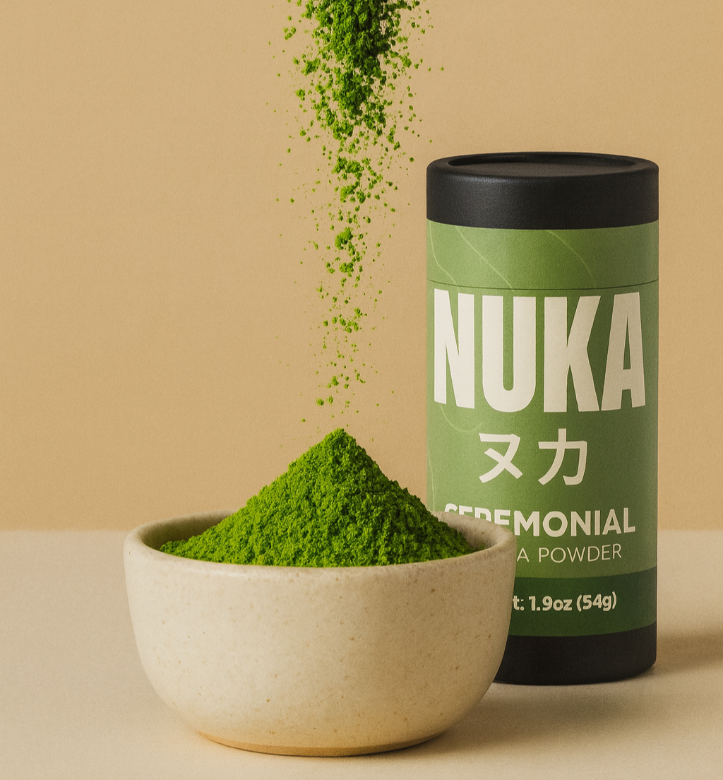 Nuka ceremonial matcha powder with a bowl of green powder on a beige background